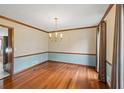 Traditional dining room with hardwood floors, chandelier, and large windows for ample natural light at 2050 Plantation Rd, Lawrenceville, GA 30044