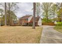 Traditional brick house with two-car garage and a long driveway situated on a spacious lot at 2050 Plantation Rd, Lawrenceville, GA 30044