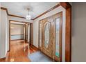 Elegant foyer with stained glass door, hardwood floors and decorative trim for a luxurious entry experience at 2050 Plantation Rd, Lawrenceville, GA 30044