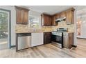 Modern kitchen with stainless steel appliances, light countertops, and a window above the sink at 2224 Bridle Ct, Norcross, GA 30071