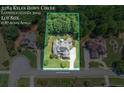 Aerial view of the property shows a home with a large lot surrounded by mature trees in a desirable neighborhood at 3284 Kylee Dawn Cir, Lawrenceville, GA 30045