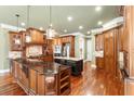 Gourmet kitchen featuring custom wood cabinets, granite countertops, stainless steel appliances and hardwood floors at 3284 Kylee Dawn Cir, Lawrenceville, GA 30045