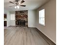 Inviting living room features a brick fireplace and new vinyl plank flooring at 942 Ellison Ct, Austell, GA 30168