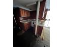 Interior showing the kitchen and appliances, though the space needs significant repair at 1581 Se Woodland Se Cir, Atlanta, GA 30316