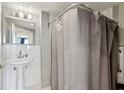 Clean bathroom with white subway tile, a pedestal sink, and a shower with a gray curtain at 215 Piedmont Ne Ave # 2103, Atlanta, GA 30308