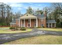 Elegant two-story brick home with a circular driveway and timeless architectural design at 3074 Cascade Sw Rd, Atlanta, GA 30311