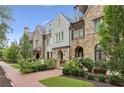 A row of beautifully designed townhouses showcases unique architectural details and lush landscaping at 55 Church St, Alpharetta, GA 30009