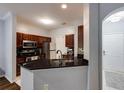Modern kitchen with stainless steel appliances, granite countertops, and a breakfast bar at 5641 Roswell Rd # 307, Sandy Springs, GA 30342
