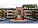 Charming brick apartment building with large arched window and well-maintained landscaping at 214 Ridley Howard Ct, Decatur, GA 30030