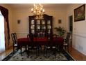 Formal dining room with a large china cabinet, chandelier, and elegant table setting at 5700 Thrasher Ln, Conyers, GA 30094