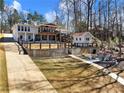 Rear exterior view of home with fenced yard, patio area, and outdoor storage building at 6041 Blackberry Ln, Buford, GA 30518
