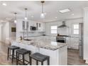 Bright kitchen boasts stainless steel appliances, granite countertops, and a breakfast bar at 6041 Blackberry Ln, Buford, GA 30518