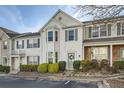Traditional-style townhouse featuring white siding, bay window, and a charming front entrance at 2015 Kilmington Sq, Alpharetta, GA 30009