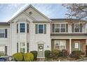 Traditional-style townhouse featuring white siding, bay window, and a charming front entrance at 2015 Kilmington Sq, Alpharetta, GA 30009