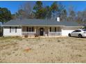 Charming single-story home featuring a well-maintained front yard, white picket fence and attached garage at 230 Laurel Way, Covington, GA 30016
