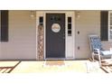 Inviting front entrance with decorative welcome sign and rocking chair, creating a warm and friendly ambiance at 230 Laurel Way, Covington, GA 30016