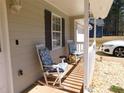 Cozy front porch featuring comfortable rocking chairs, perfect for enjoying the outdoors and relaxing at 230 Laurel Way, Covington, GA 30016