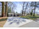 Wide driveway leading to a charming single-story home with gray exterior and carport at 4985 Crowe Se Dr, Smyrna, GA 30082