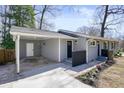 Charming single-story home with grey siding, covered carport and black trim at 4985 Crowe Se Dr, Smyrna, GA 30082