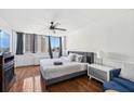 Sunlit bedroom with large windows, hardwood floors, and a stylish ceiling fan at 215 Piedmont Ne Ave # 2109, Atlanta, GA 30308
