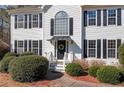 Charming two-story home with black shutters, landscaping, and covered entry at 434 Westchester Way, Canton, GA 30115