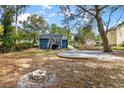 Spacious backyard featuring a fire pit, a patio space, and lush trees at 578 Cedar Avenue, Atlanta, GA 30318