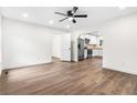 A spacious living room with sleek ceiling fan and modern flooring, flowing into the kitchen at 578 Cedar Avenue, Atlanta, GA 30318