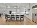 Bright kitchen features white cabinetry, a large island with seating, and stainless steel appliances at 1112 Kensington Ct, Johns Creek, GA 30022