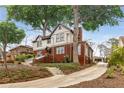 Rear exterior view of home, showing landscaped yard, driveway and detached garage at 591 E Morningside Ne Dr, Atlanta, GA 30324
