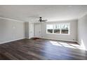 Sun-lit living area featuring new flooring, fresh paint, and a ceiling fan at 2811 Birchwood Sw Ct, Marietta, GA 30060