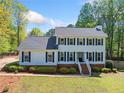 Traditional two-story home with a well-manicured lawn, brick foundation, and symmetrical window placement at 3040 Wax Wing Nw Ct, Kennesaw, GA 30144