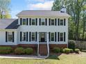 Inviting two-story home with a brick-lined foundation and a beautifully landscaped front yard at 3040 Wax Wing Nw Ct, Kennesaw, GA 30144