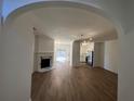 Open living room with hardwood floors and a fireplace, flowing into the kitchen and dining area at 358 Azalea Cir, Cumming, GA 30040