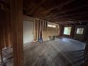 Bedroom featuring exposed beams, a closet, and a window needing remodeling at 1713 Cahoon St, Atlanta, GA 30310