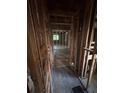 Hallway featuring exposed framing, hardwood floors and an air vent awaiting remodeling at 1713 Cahoon St, Atlanta, GA 30310