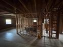 Spacious living room featuring exposed framing, windows, and hardwood floors awaiting remodeling at 1713 Cahoon St, Atlanta, GA 30310