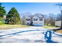 Well-maintained home featuring a long driveway and neatly kept lawn, surrounded by mature trees at 52 Newman Dr, Villa Rica, GA 30180