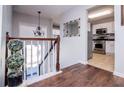 Welcoming foyer with hardwood floors, a staircase, and views into the kitchen area at 52 Newman Dr, Villa Rica, GA 30180