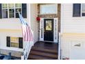 Inviting front entrance with stone accents, decorative details, and freshly stained wooden steps at 52 Newman Dr, Villa Rica, GA 30180