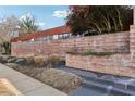 Exterior view of the building, featuring brick facade, landscaping and signage for Arizona Lofts at 195 Arizona Ne Ave # 131, Atlanta, GA 30307