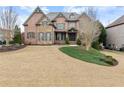 Attractive two-story home with a well-maintained lawn, brick and stone facade, and inviting curb appeal at 6040 Boulder Bluff Dr, Cumming, GA 30040
