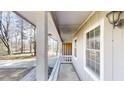 Covered porch with white pillars and railing, offering a cozy outdoor space at 3359 Mansfield Ln, Snellville, GA 30039