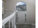 Close up of front door and large arched window, showcasing the home's bright and welcoming foyer at 6334 Milo Dr, Austell, GA 30168