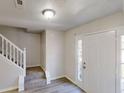 Inviting entryway with a white front door, staircase and hardwood floors at 6643 Hill Creek Cv, Lithonia, GA 30058