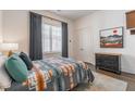 Cozy bedroom with soft rug, accent wall decor, and natural light from a large window at 1200 Ponce De Leon Ne Ave # A-19, Atlanta, GA 30306