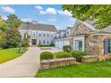 Charming gray home with stone accents, a three-car garage, and a well-manicured front yard at 3185 Casteel Ne Rd, Marietta, GA 30062