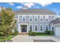 Charming two-story home with a welcoming front porch, well-manicured landscaping, and gray shingle siding at 3185 Casteel Ne Rd, Marietta, GA 30062