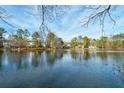 Scenic view of the lake showcasing waterfront properties and lush greenery at 3185 Casteel Ne Rd, Marietta, GA 30062