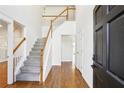 Bright foyer with hardwood floors, staircase, and white walls at 3242 Monarch Pine Nw Dr, Peachtree Corners, GA 30071