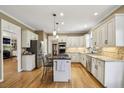 Updated kitchen featuring stainless steel appliances, white cabinetry, and a central island at 535 Cameron Manor Way, Atlanta, GA 30328